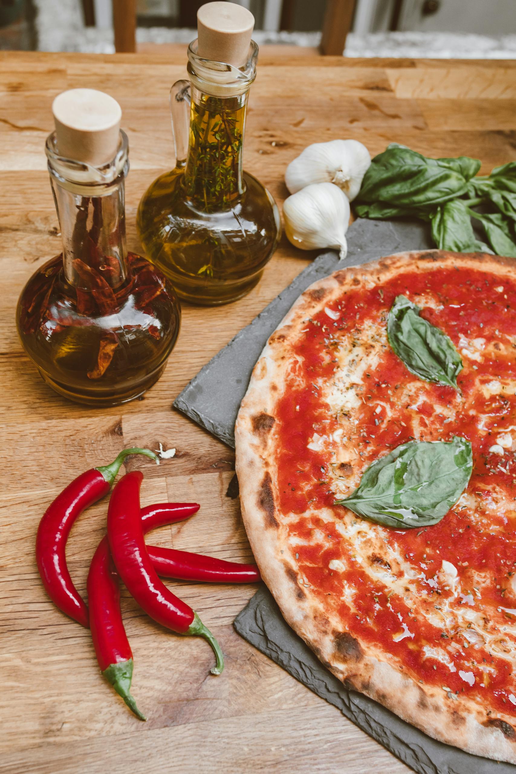 Delicious Italian pizza with fresh basil and olive oil on a wooden table.